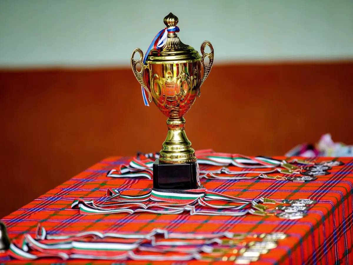 Golden trophy and medals on a table