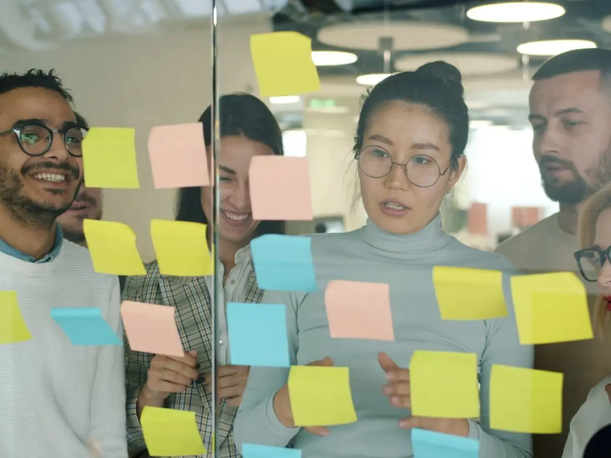 Team planning with sticky notes on a glass wall