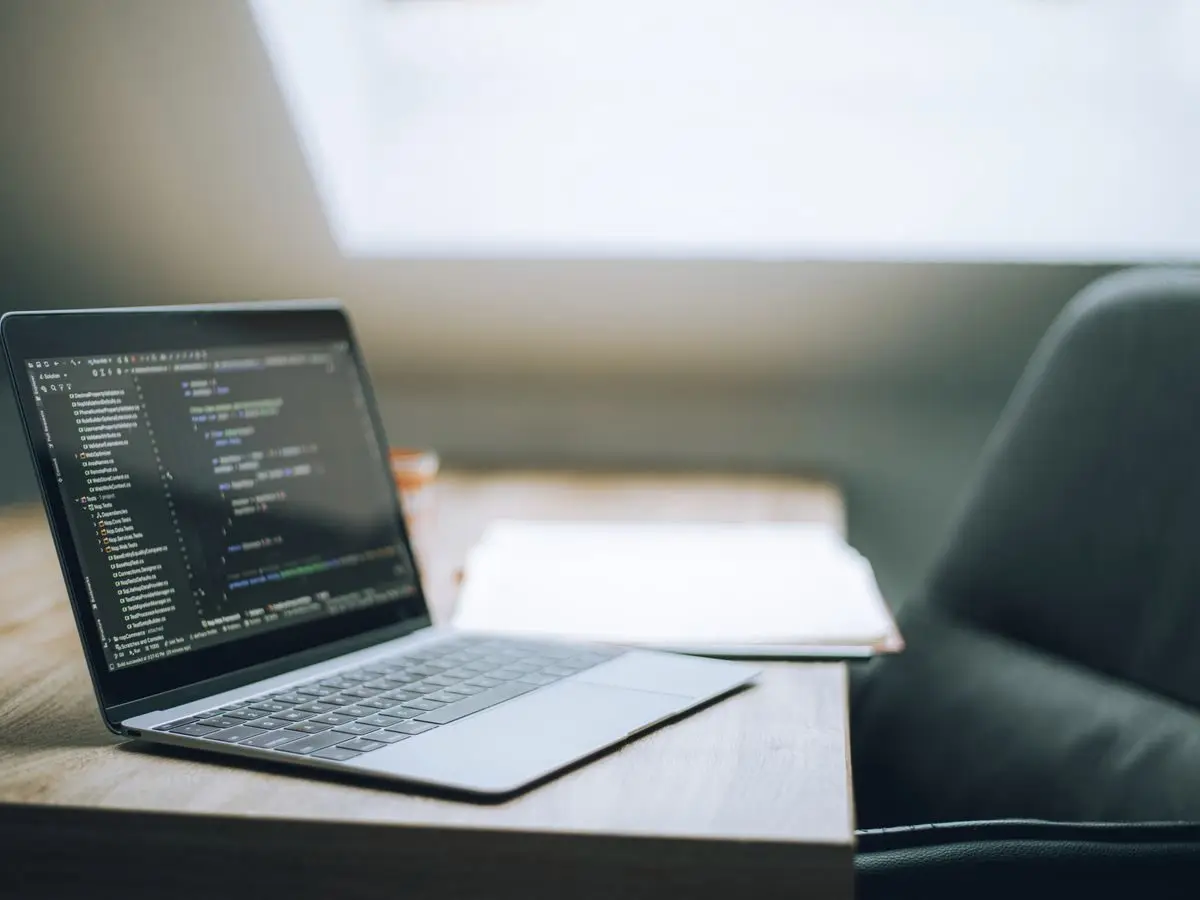 Laptop with code in a bright office