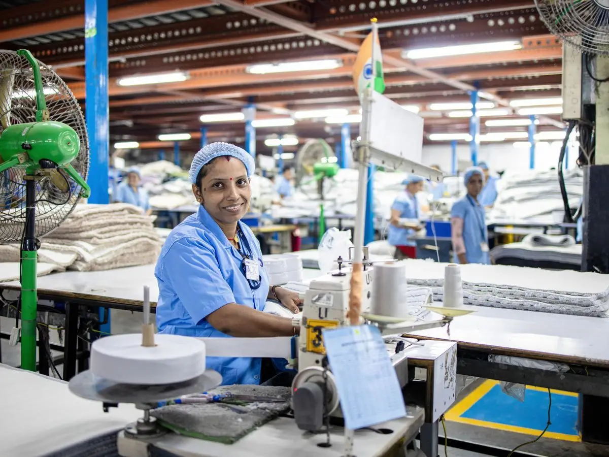 Worker at a sewing machine in a factory