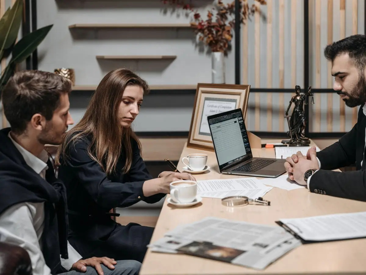 Professionals reviewing a contract over coffee