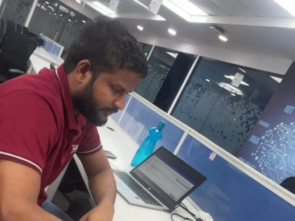 An INK consultant at work on his laptop in the office