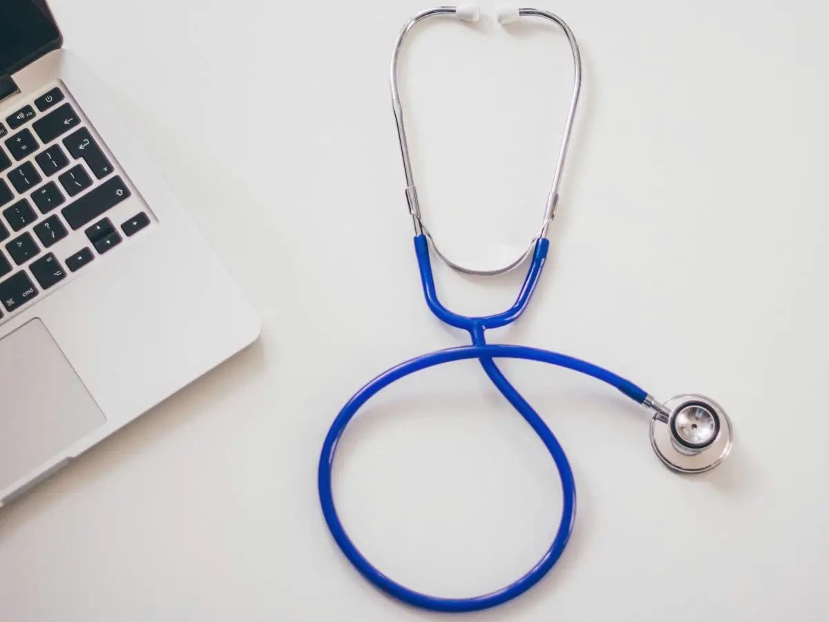 Stethoscope beside a laptop