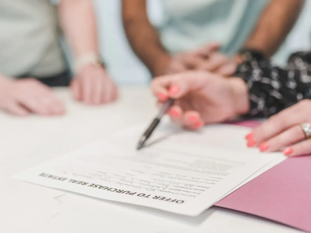 People reviewing and signing a document
