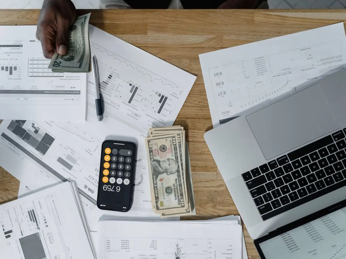 Desk with financial documents and a laptop