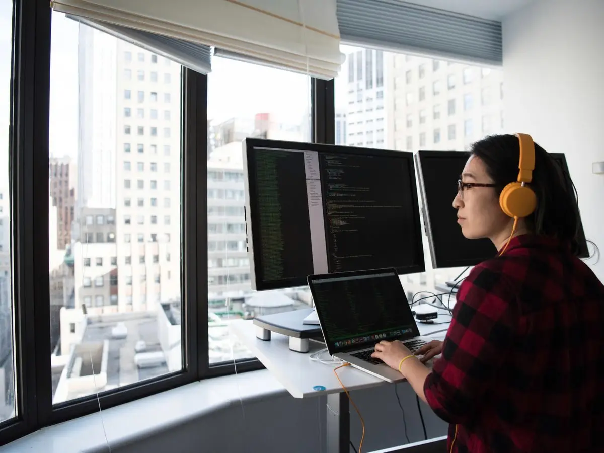 Engineer coding at a standing desk