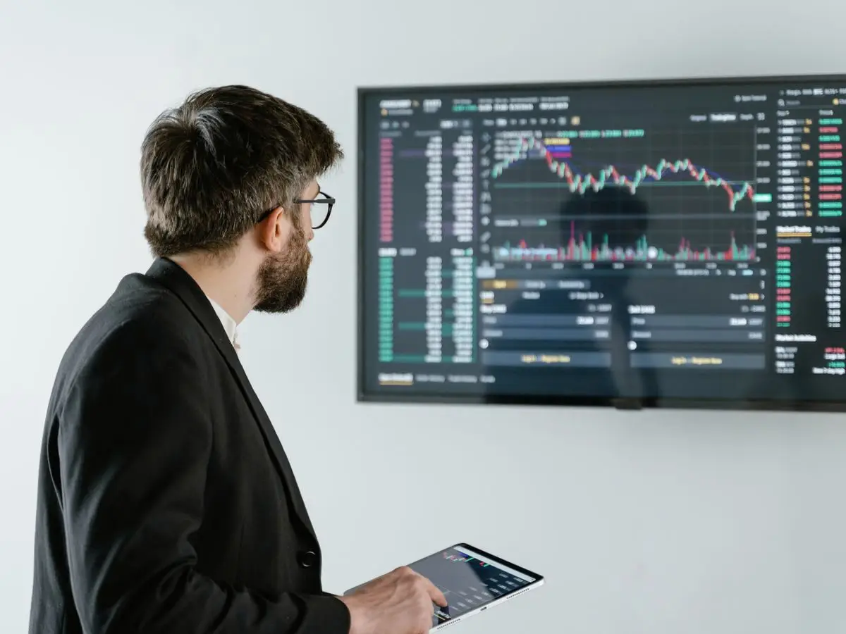 Analyst reviewing market data on a screen
