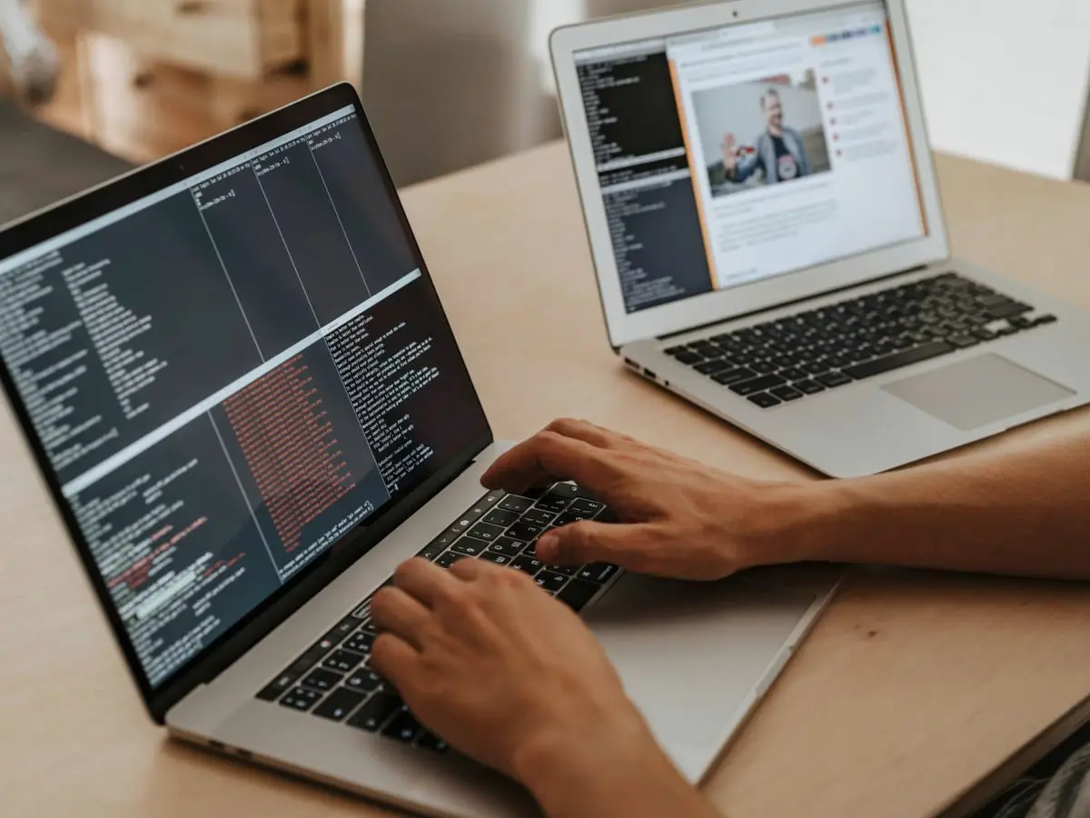 Developer typing code on a laptop