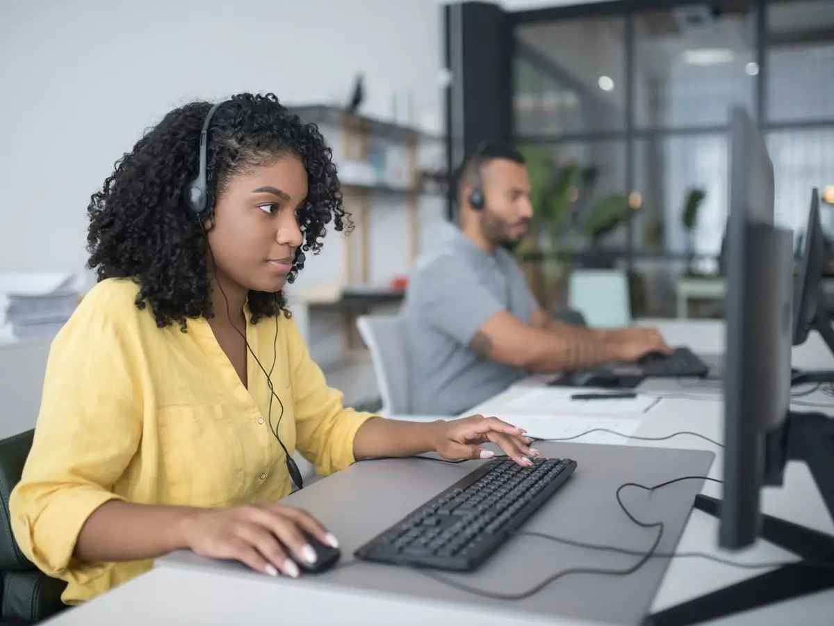 Two service desk agents with headsets