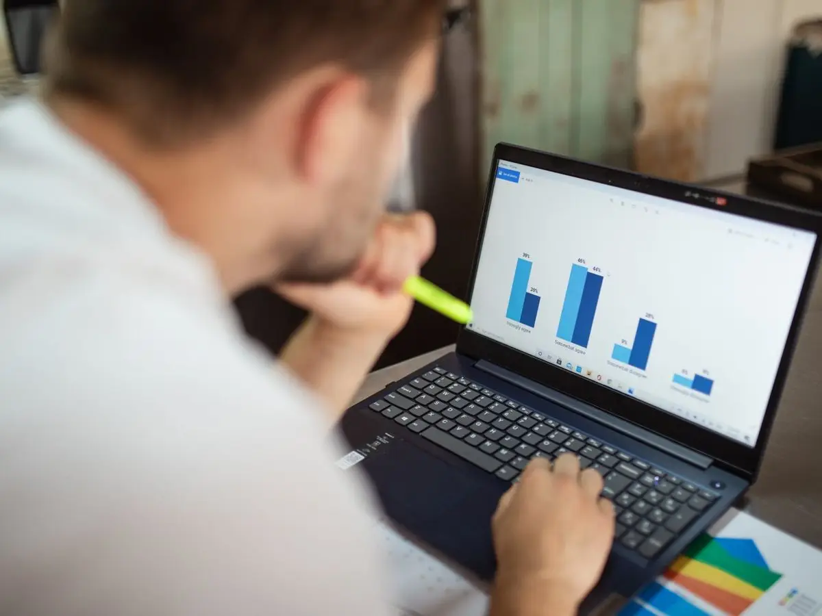 Reviewing business charts on a laptop